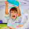 Boy emptying his pencil case on a table angrily