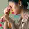 Lady looking stressed holding her glasses