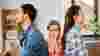 Girl sitting between her parents who face away from each other
