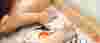 Toddler with their hands in a sand tray