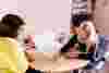 A young girl and a counsellor working on a project together, during a school counselling session