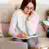 Mum working from home with a child next to her
