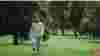 Girl walking alone through a park