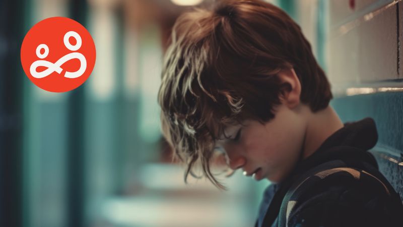 Teenager feeling sad in school corridor